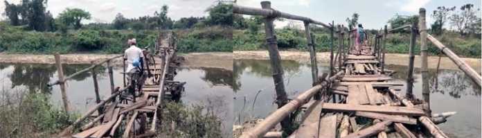 Villagers of Gudavasal district crossing the river on a dangerous wooden bridge -1